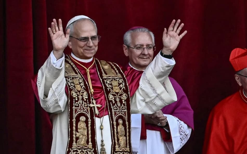 Newly elected Pope Leo XIV, Robert Prevost (L) gestures as he arrives on the main central loggia balcony of the St Peter's Basilica for the first time, after the cardinals ended the conclave, in The Vatican, on May 8, 2025. Robert Francis Prevost was on Thursday elected the first pope from the United States, the Vatican announced. A moderate who was close to Pope Francis and spent years as a missionary in Peru, he becomes the Catholic Church's 267th pontiff, taking the papal name Leo XIV. (Photo by Filippo MONTEFORTE / AFP)