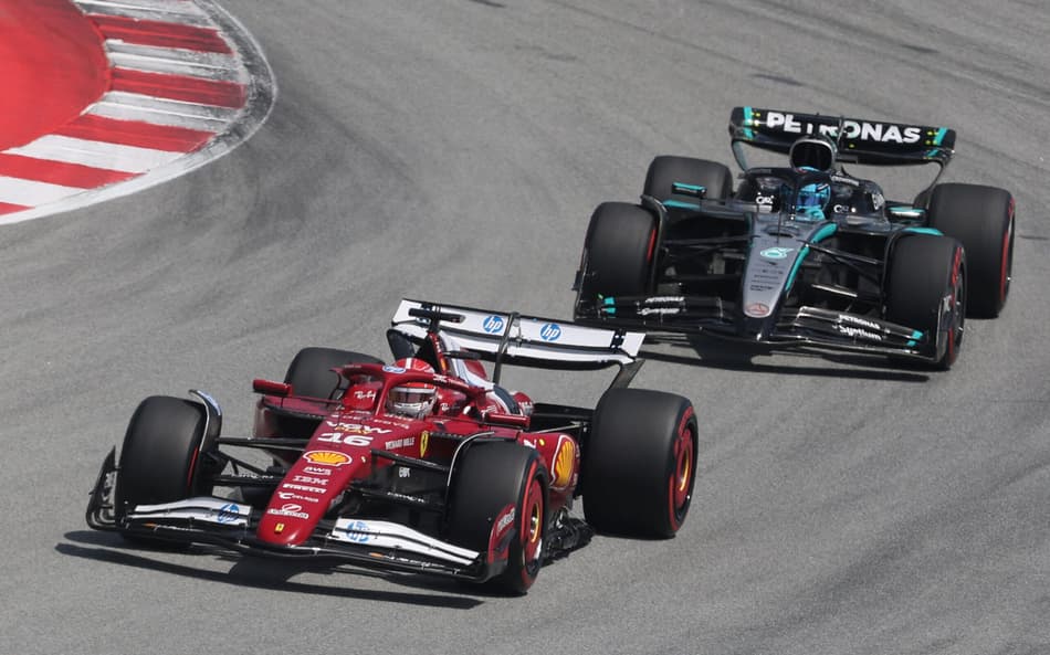 Ferrari's Monegasque driver Charles Leclerc drives ahead of Mercedes' British driver George Russell during the Spanish Formula One Grand Prix at the Circuit de Catalunya in Montmelo, on the outskirts of Barcelona, on June 1, 2025. (Photo by Pierre-Philippe MARCOU / AFP)
