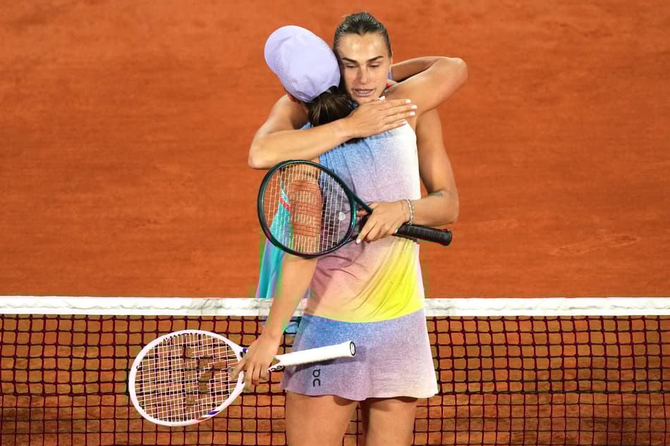 Winner Belarus' Aryna Sabalenka (R) cheers Poland's Iga Swiatek at the end of their women's singles semi-final match on day 12 of the French Open tennis tournament on Court Philippe-Chatrier at the Roland-Garros Complex in Paris on June 5, 2025. (Photo by Dimitar DILKOFF / AFP)