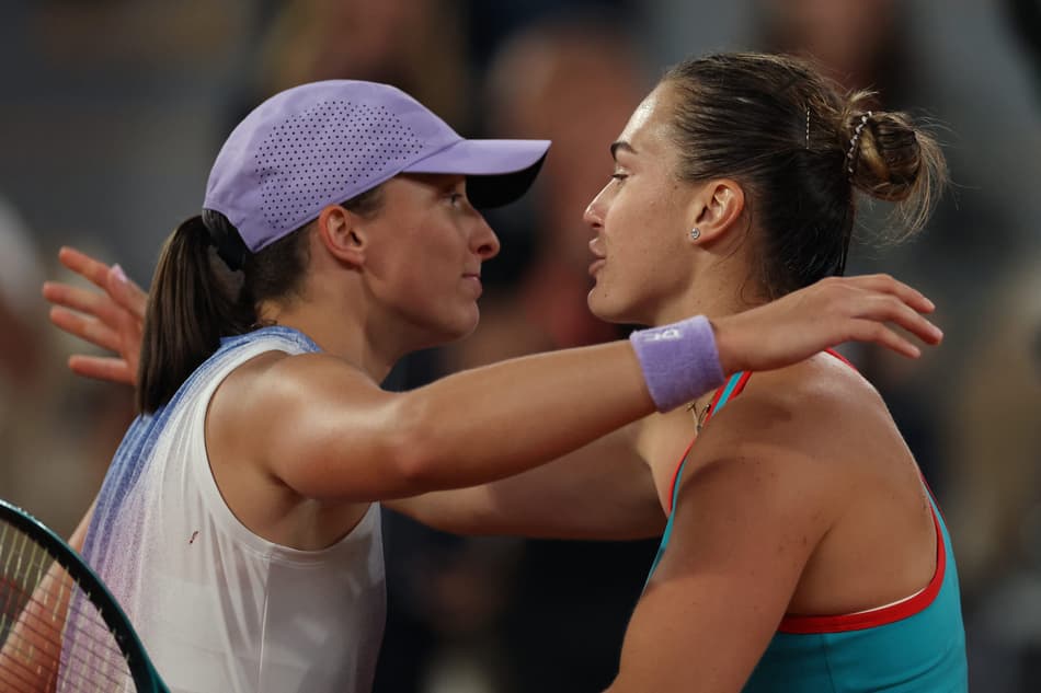 Belarus' Aryna Sabalenka (R) comforts Poland's Iga Swiatek after defeating her in their women's singles semi-final match on day 12 of the French Open tennis tournament on Court Philippe-Chatrier at the Roland-Garros Complex in Paris on June 5, 2025. (Photo by Alain JOCARD / AFP)