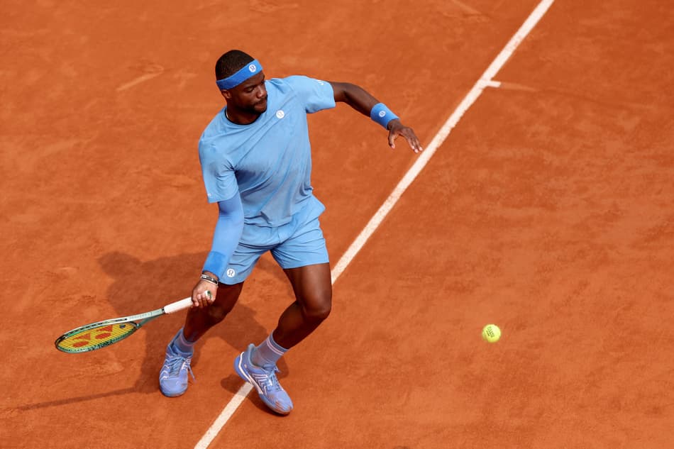 US Frances Tiafoe plays a forehand return to Italy's Lorenzo Musetti during their quarter-final men's singles match on day 10 of the French Open tennis tournament on Court Philippe-Chatrier at the Roland-Garros Complex in Paris on June 3, 2025. (Photo by ALAIN JOCARD / AFP)