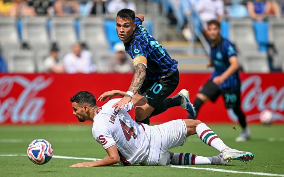 Fluminense's Brazilian defender #04 Ignacio (L) tackles Inter Milan's Argentine forward #10 Lautaro Martinez (C) preventing a goal scoring opportunity during the FIFA Club World Cup 2025 round of 16 football match between Italy's Inter Milan and Brazil's Fluminense at the Bank of America Stadium in Charlotte on June 30, 2025. (Photo by Paul ELLIS / AFP)