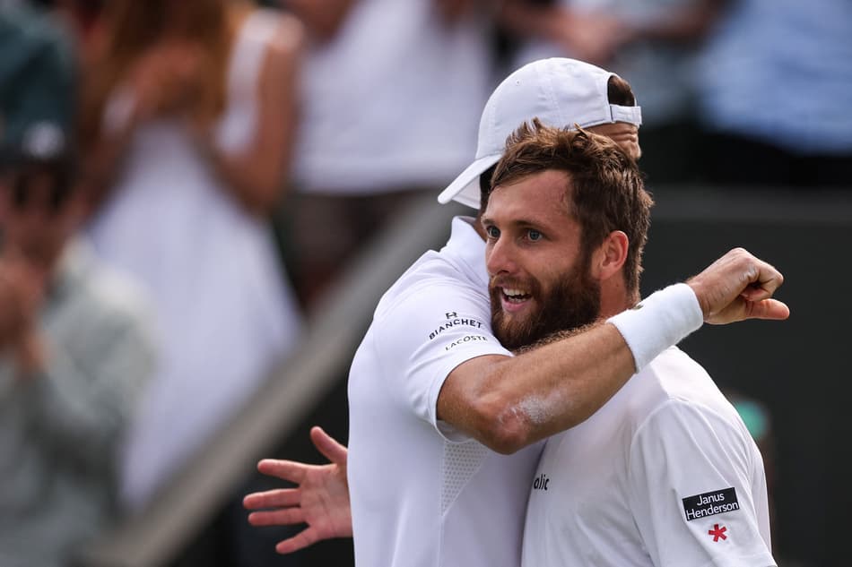 O búlgaro Grigor Dimitrov (e) abraça o francês Corentin Moutet após a vitória em Wimbledon (Fto: HENRY NICHOLLS / AFP)
