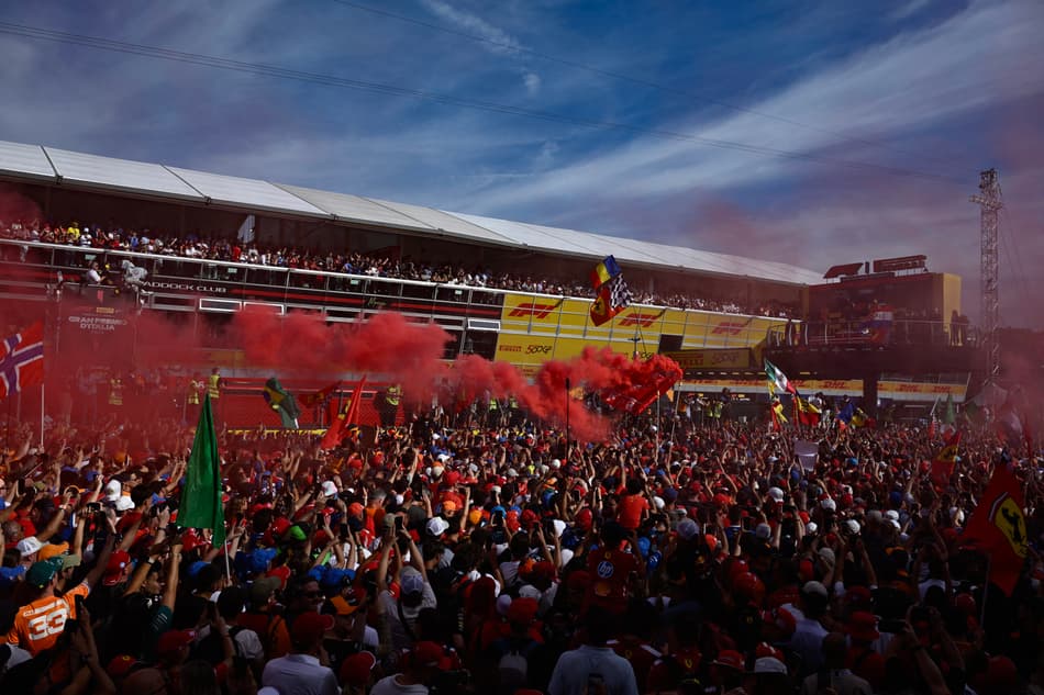 Spectators gather around the podium area on the track after the Italian Formula One Grand Prix at the Autodromo Nazionale Monza circuit, in Monza, northern Italy, on September 7, 2025. (Photo by Philippe Lopez / AFP)