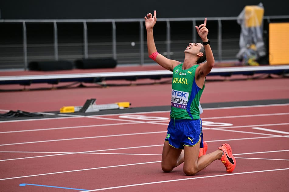 Silver medallist Brazil's athlete Caio Bonfim celebrates after crossing the finish line of the men's 35km race walk final during the World Athletics Championships in Tokyo on September 13, 2025. (Photo by Ben STANSALL / AFP)