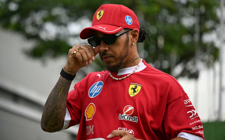 Ferrari's British driver Lewis Hamilton arrives for the first practice session ahead of the Formula One Singapore Grand Prix night race at the Marina Bay Street Circuit in Singapore on October 3, 2025. (Photo by MOHD RASFAN / AFP)