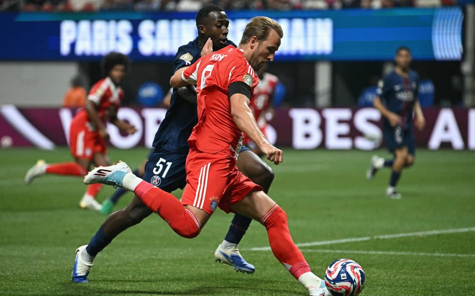 Harry Kane e Pacho disputam a bola em PSG x Bayern (Foto: Paul ELLIS / AFP)