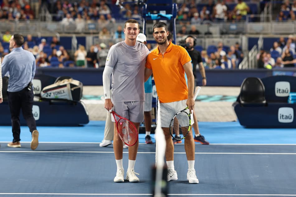 MIAMI, FLORIDA - DECEMBER 08: Joao Fonseca of Brazil and Carlos Alcaraz of Spain look on before their match during the Miami Invitational at loanDepot park on December 08, 2025 in Miami, Florida. Tomas Diniz Santos/Getty Images/AFP (Photo by Tomas Diniz Santos / GETTY IMAGES NORTH AMERICA / Getty Images via AFP)