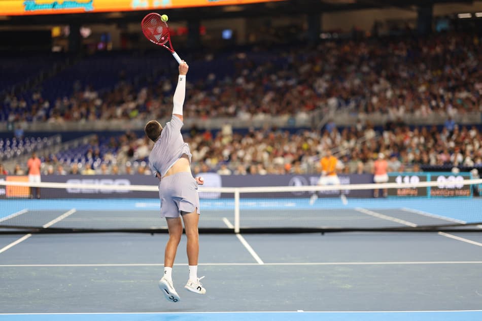 MIAMI, FLORIDA - DECEMBER 08: Joao Fonseca of Brazil serves against Carlos Alcaraz of Spain during the Miami Invitational at loanDepot park on December 08, 2025 in Miami, Florida. Tomas Diniz Santos/Getty Images/AFP (Photo by Tomas Diniz Santos / GETTY IMAGES NORTH AMERICA / Getty Images via AFP)