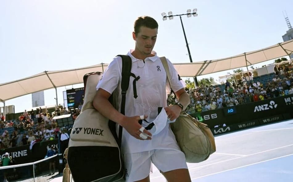 João Fonseca deixa a quadra após a derrota para Eliot Spizzirri no Australian Open (Foto: WILLIAM WEST / AFP)