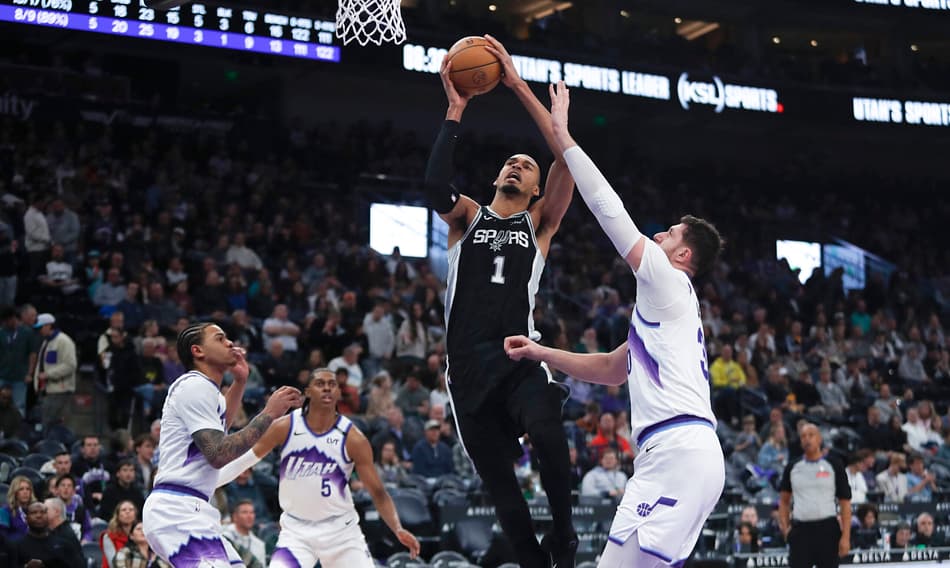 Victor Wembanyama, do San Antonio Spurs, parte para a cesta contra Jusuf Nurkic, Keyonte George e Cody Williams, do Utah Jazz, em Salt Lake City, em 22 de janeiro de 2026 (Foto: Chris Gardner/Getty Images/AFP)