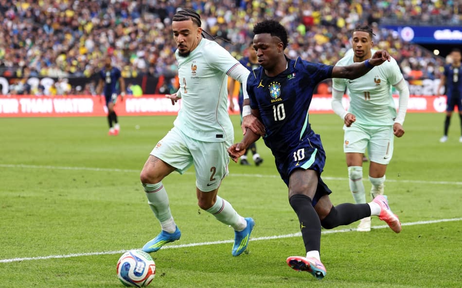Vini Jr disputa a bola com Gusto em Brasil x França (Foto: FRANCK FIFE / AFP)