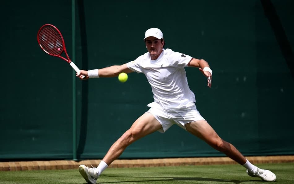 João Fonseca devolve a bola contra o espanhol Roberto Bautista Agut na estreia em Wimbledon