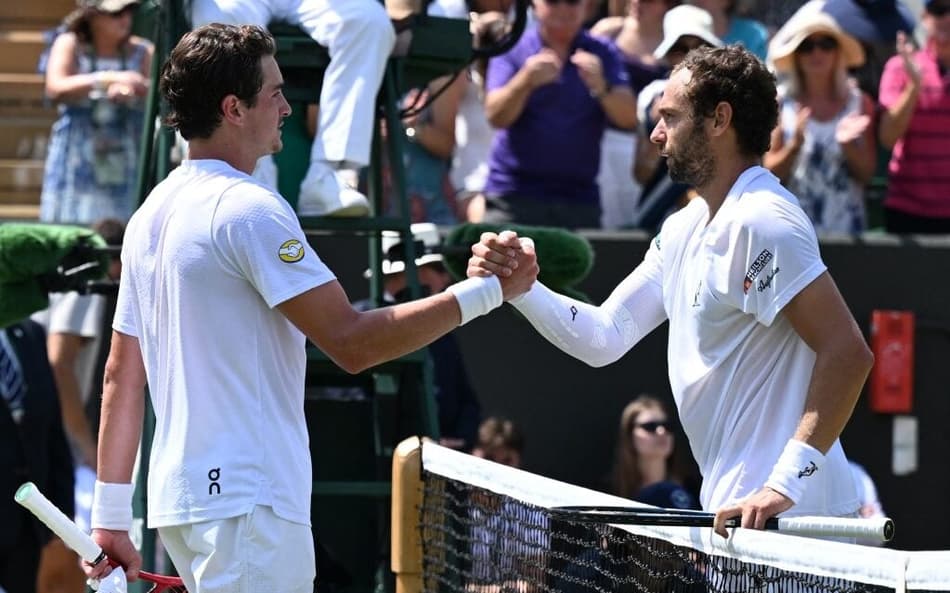 João Fonseca cumpimenta o russo Roman Safiullin após a derrota em Wimbledon