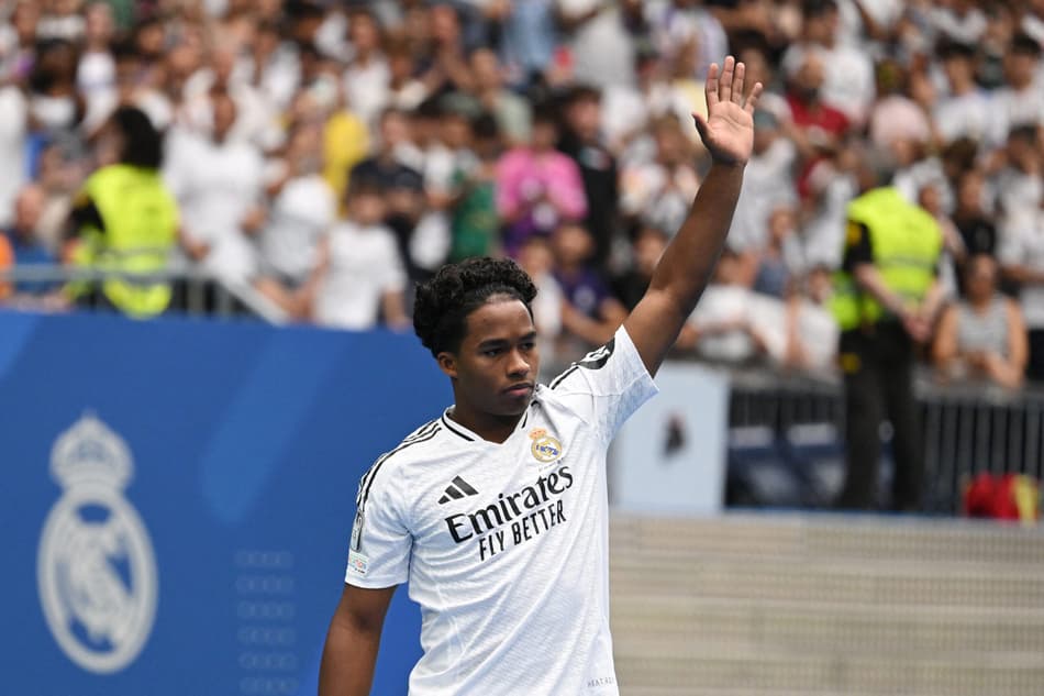 Brazilian forward Endrick Felipe waves to fans during a first appearance as a new Real Madrid player at The Santiago Bernabeu Stadium in Madrid on July 27, 2024. (Photo by JAVIER SORIANO / AFP)